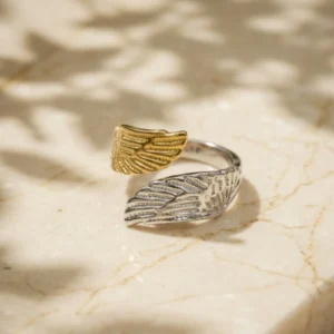 Two-tone Winged Ring photographed on a marble background